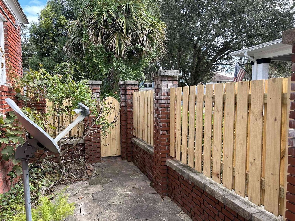 Wood gate with brick columns