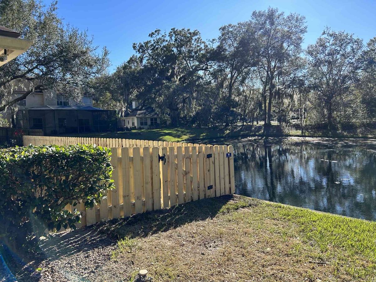 Wood picket fence beside a Jacksonville pond